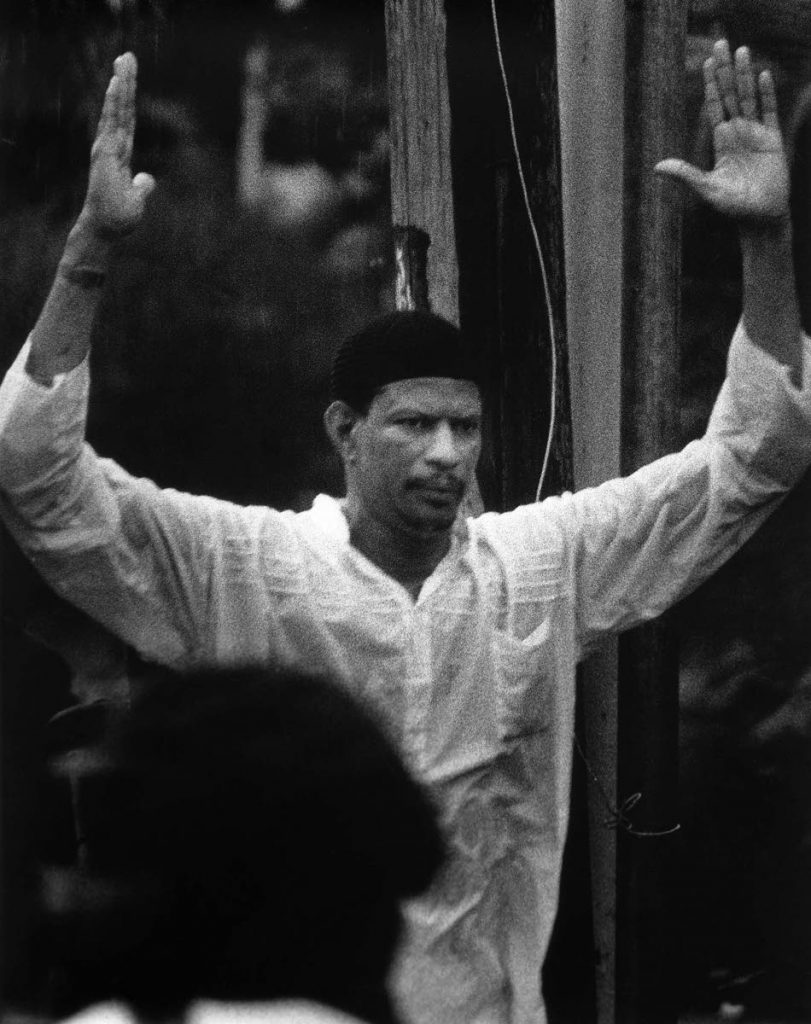 FILE PHOTO: Leader of the Jamaat al Muslimeen Yasin Abu Bakr surrenders to army forces on August 1, 1990, after staging an attempted coup on July 27, 1990 - Photo courtesy Mark Lyndersay
