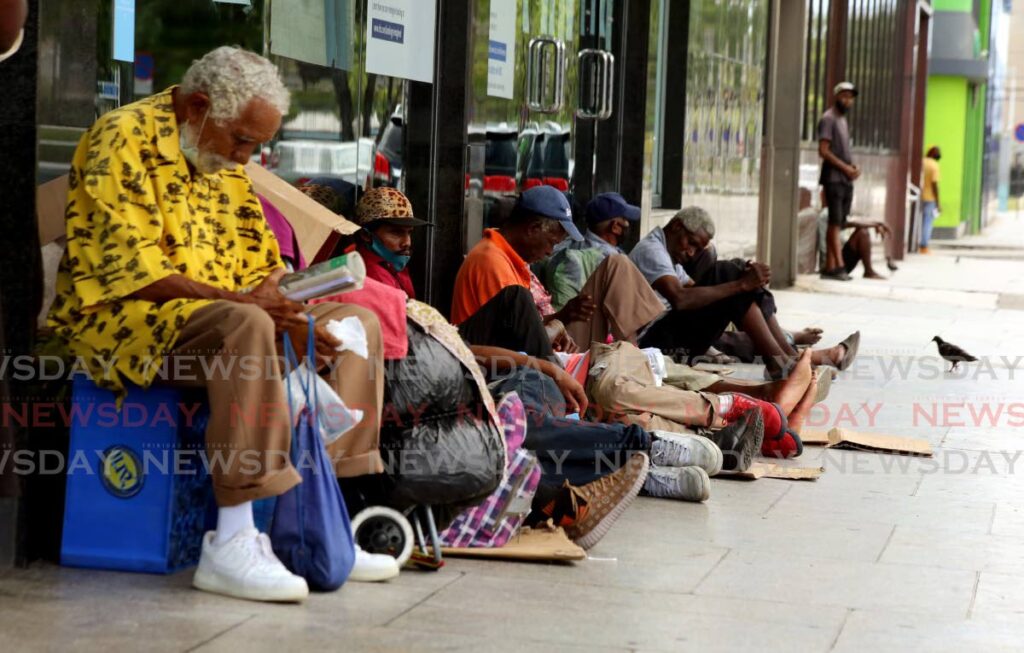 Elderly men among the homeless outside a bank in Port of Spain on June 6, 2021. - PHOTO BY SUREASH CHOLAI