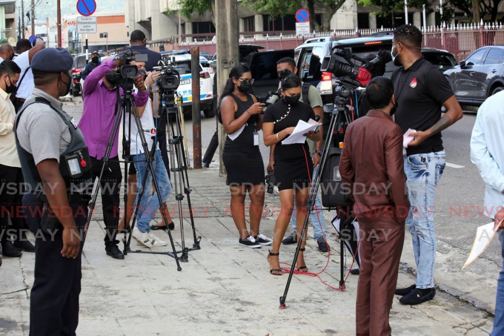 In this photo taken on October 4 members of the media wait outside the Red House in Port of Spain. When navigating crises in business, use the media to tell your story and have it understood. - SUREASH CHOLAI