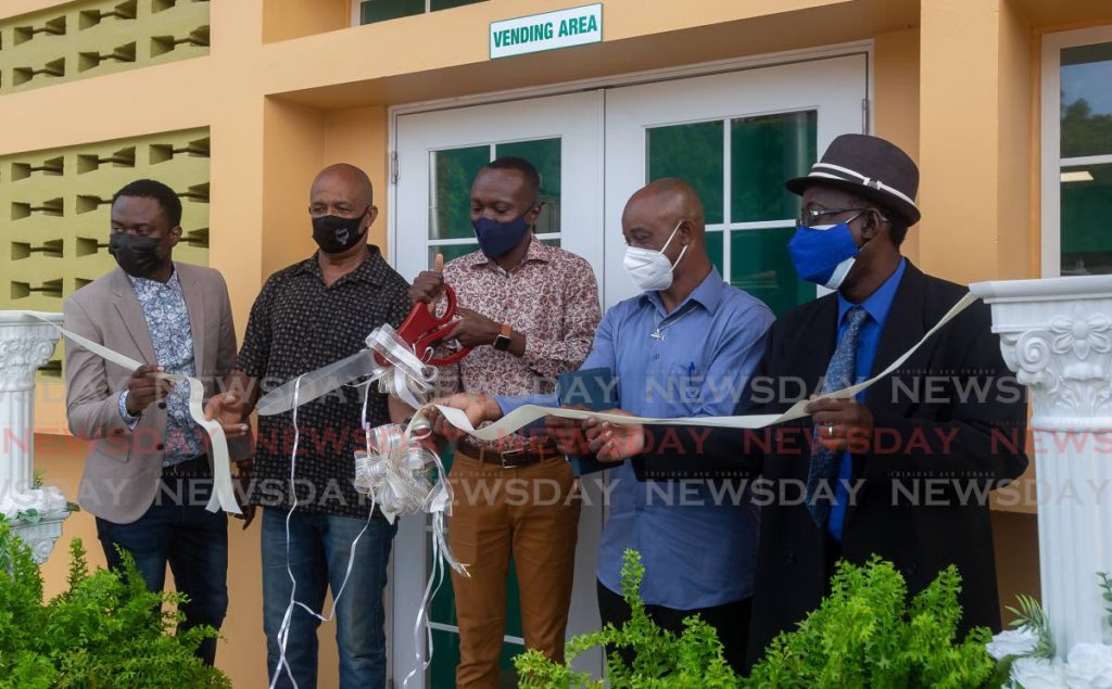 Chief Secretary Ancil Denis, centre, cuts the ribbon to officially open the Castara Fishing Facility on Sunday. Also present at the ceremony were (from left) electoral representative Farley Augustine; Garth Ottley, director, Department of Marine Affairs and Fisheries; Errol Roach, member of the Castara fishing community; and Wendel Bernard, Administrator, Division of Food Production, Foresty and Fisheries, on Sunday. Photo by David Reid