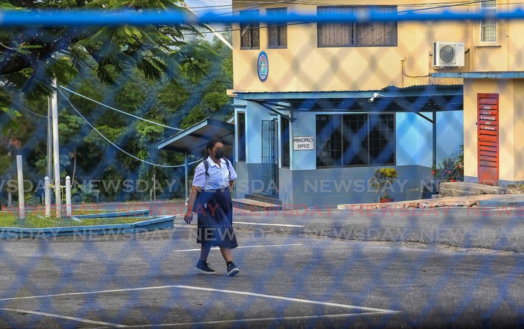 A form five student walks through the yard of Iere High School, Siparia, on Monday. - Photo by Lincoln Holder