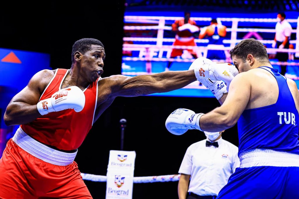 TT heavyweight boxer Nigel Paul (left) and Turkey's Berat Acar compete during the International Boxing Association World Championships 2021, in Belgrade, Serbia, on Tuesday. PHOTO COURTESY AIBA. - 