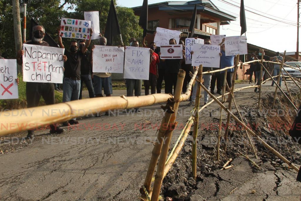 Bad roads and water woes led the residents of Realize Road, Princes Town, to protest on Wednesday morning. - Marvin Hamilton