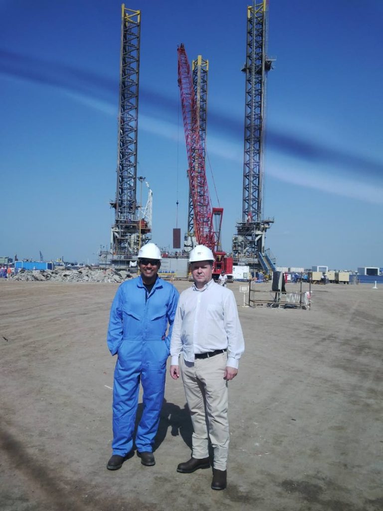 Risk manager Randall Mohammed, left, and a Spanish colleague during a site visit of a drilling rig in Abu Dhabi.  - PHOTO COURTESY RANDALL MOHAMMED