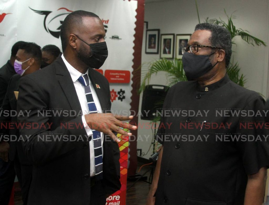 Minister of Public Utilities Marvin Gonzales, left, speaks with TTPOST's chairman Hakeem Ahmad at the TTPOST Track and Trace Launch,  at TTPOST National Mail Centre, Piarco, on Friday. - Angelo Marcelle