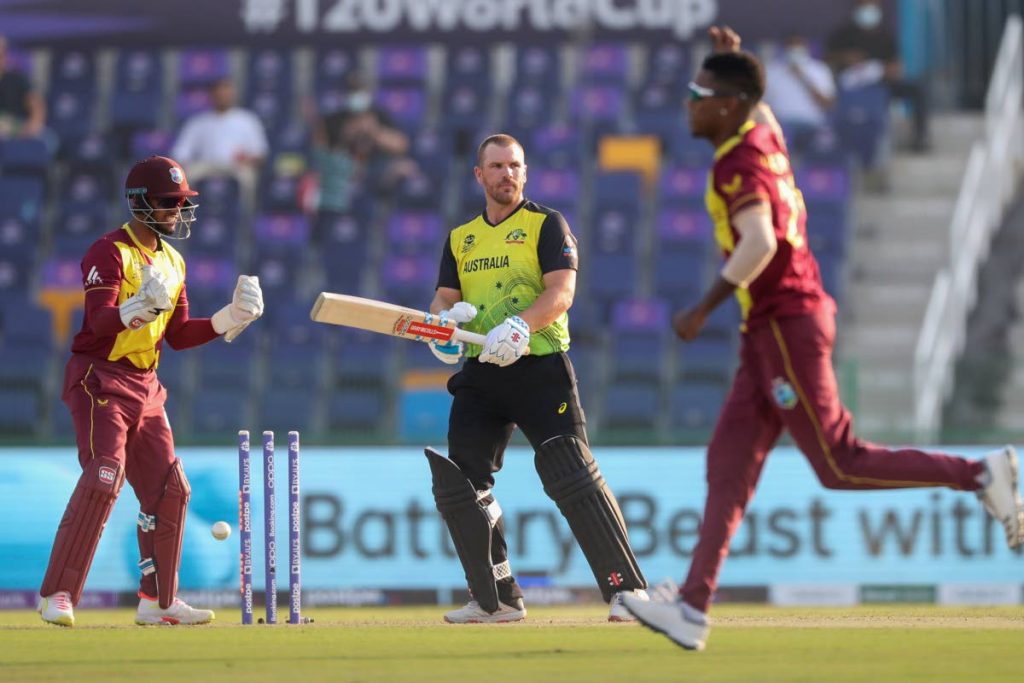 Australia's captain Aaron Finch, centre, reacts after he was dismissed by West Indies' Akeal Hosein, right, during the ICC Twenty20 World Cup match in Abu Dhabi, UAE, on Saturday. (AP Photo) - 