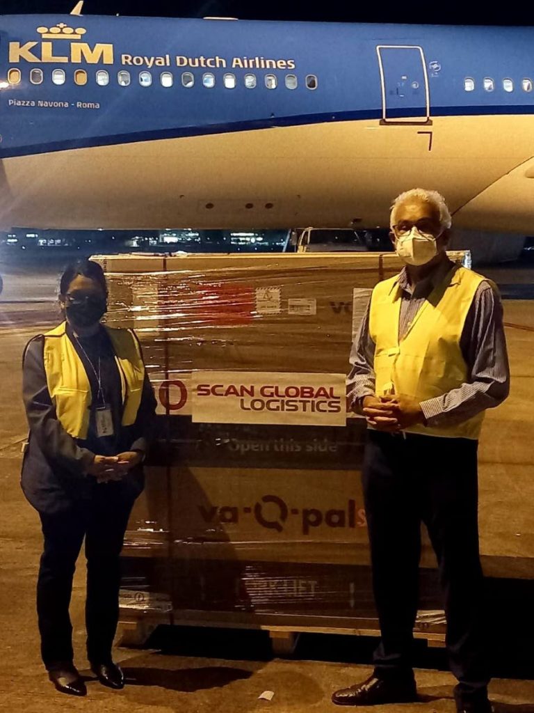 Health Minister Terrence Deyalsingh and and Anesa Doodnath-Siboo, principal pharmacist, receive a new batch of 151,200 Johnson & Johnson vaccines at Piarco International Airport on Saturday night. Photo courtesy Ministry of Health