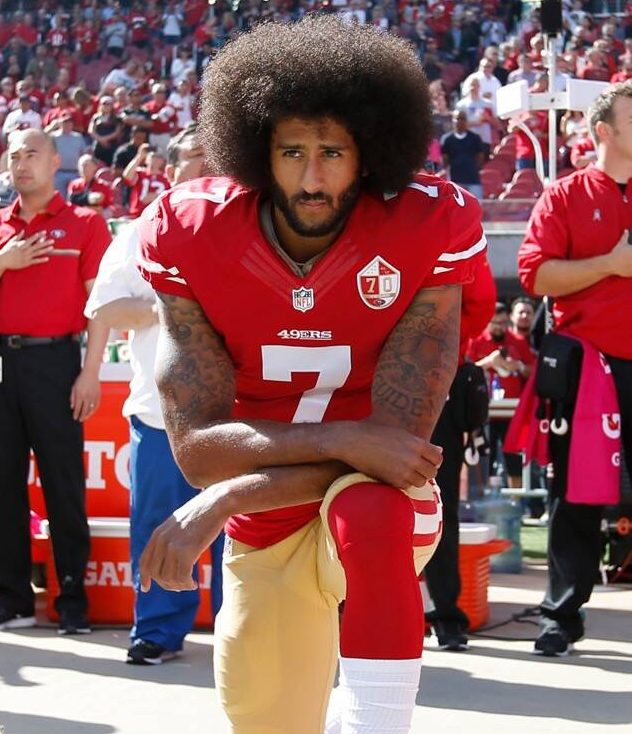 Former San Francisco 49ers quarterback Colin Kaepernick takes a knee during the US national anthem to protest racial inequality.
