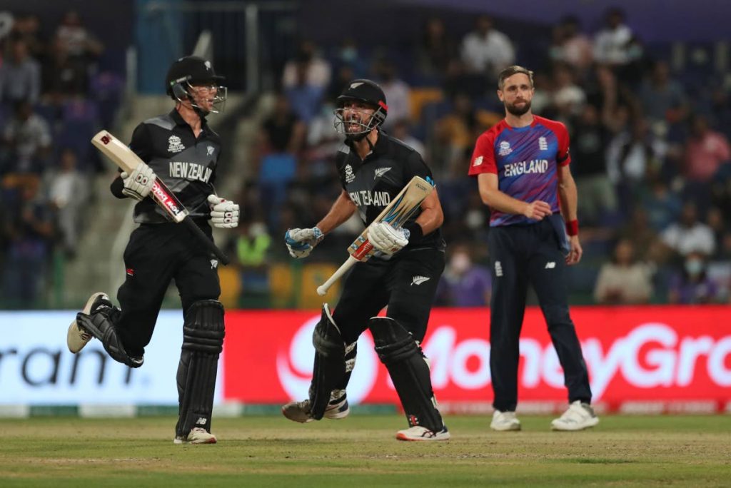 New Zealand's Daryl Mitchell, centre, and Mitchell Santner celebrate winning the ICC Twenty20 World Cup semi-final match against England in Abu Dhabi, UAE, on Wednesday. (AP Photo) - 