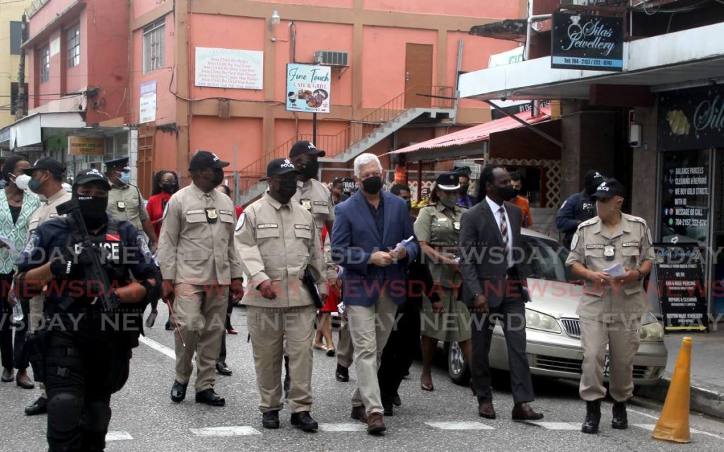 National Security Minister Fitzgerald Hinds, Deputy Commisioner of Police, McDonald Jacob and Port of Spain Mayor Joel Martinez tour the city with officers of the municipal police unit at the launch of its Christmas Anti-Crime Plan on Wednesday. - ROGER JACOB
