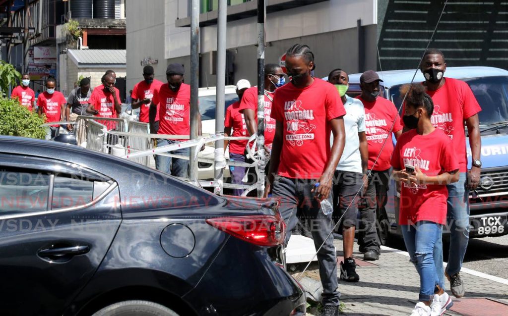 Footballers, coaches and supporters walk through Port of Spain, on Thursday, over the shutdown of sports due to the coronavirus pandemic.  - SUREASH CHOLAI