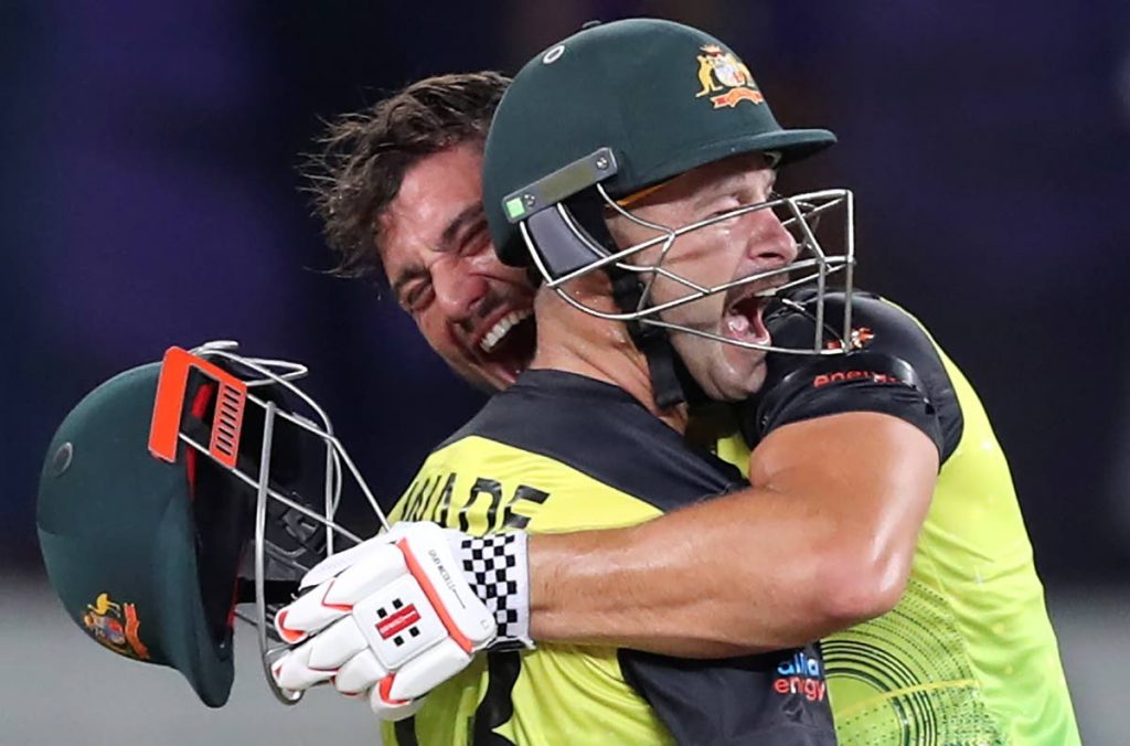 Australia's Marcus Stoinis, holding helmet, and Matthew Wade celebrate after winning the Cricket Twenty20 World Cup semi-final match between Pakistan and Australia in Dubai, UAE, Thursday. (AP Photo) - 