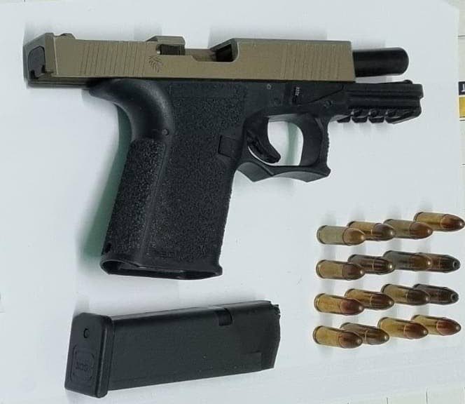 SEIZED: The nine-millimetre semi-automatic pistol and ammunition seized by police during a raid on a house in Malabar on Friday morning. Four people were subsequently arrested. PHOTO COURTESY TTPS - ttps