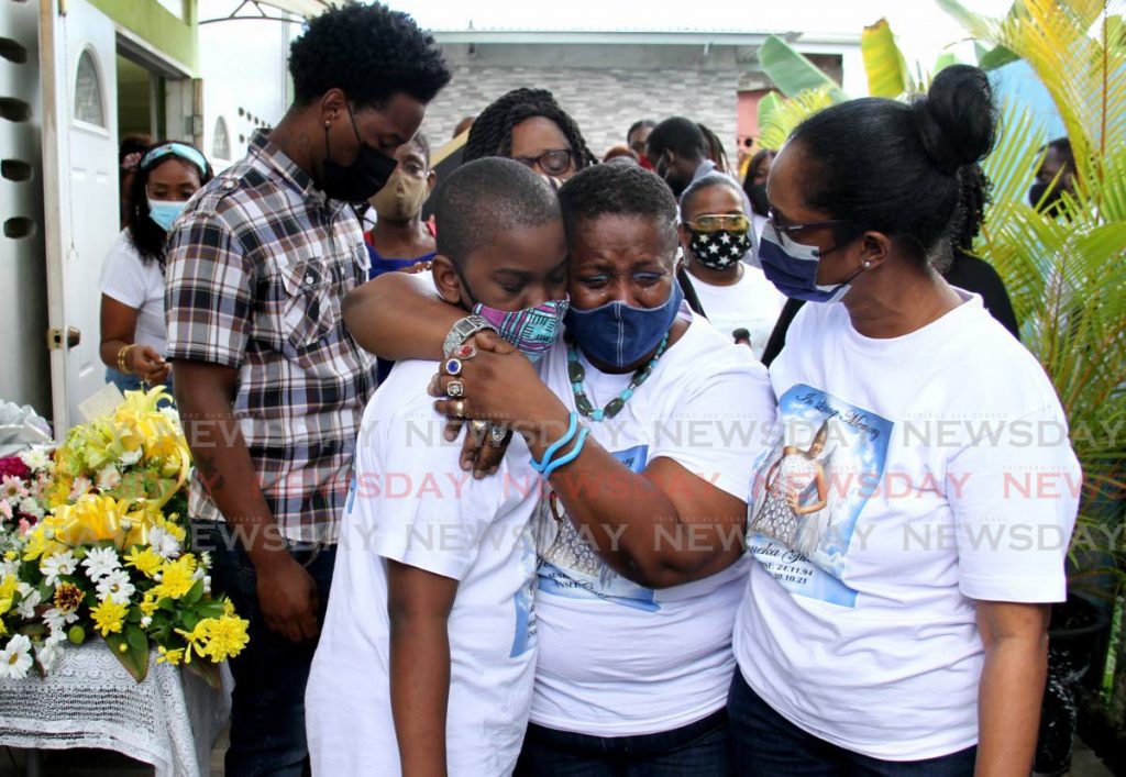 A weeping Aretha Johnson hugs her son Jovannie at the funeral for her murdered daughter Jeneka Guerra. PHOTO BY AYANNA KINSALE  