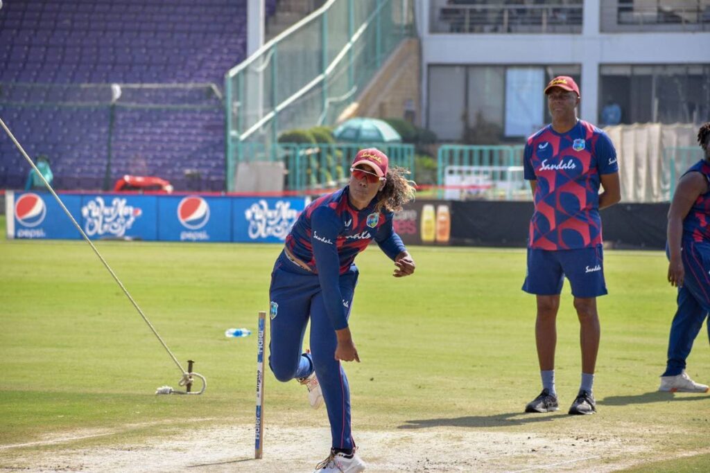 West Indies Women off-spinner Hayley Matthews (left) bowls a delivery while coach Courtney Walsh looks on during a practice session at the National Stadium, Karachi, Pakistan on Saturday. PHOTO COURTESY CRICKET WEST INDIES. - 