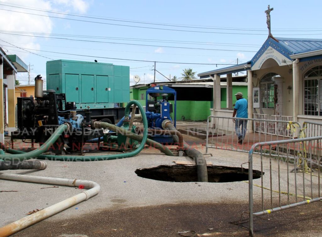 WASA repairs continue at the sinkhole on Main Street, Beetham Gardens near the Archbishop Anthony Pantin Centre for Peace Roman Catholic Chapel.  - AYANNA KINSALE