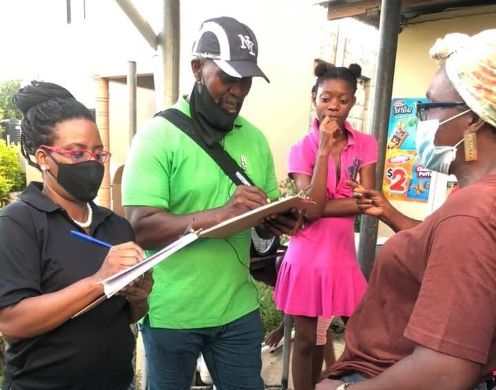 PDP candidate Sonny Craig, second from left, chats with residents of Buccoo/Mt Pleasant during a walkabout.  - 