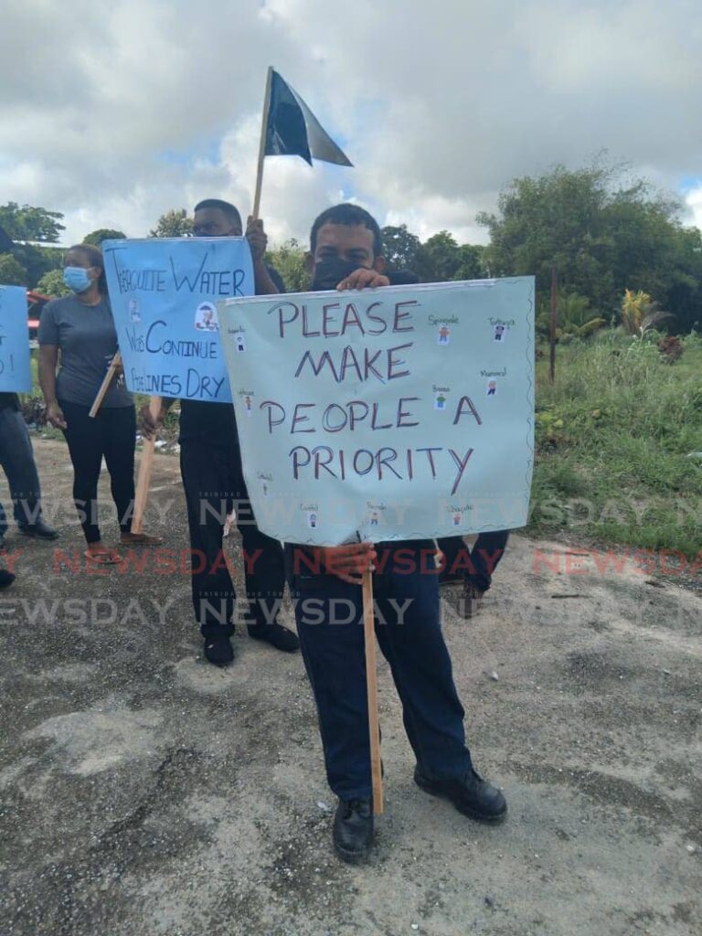 Nigel Ramharack pleads for the Ministry of Works to repair the Monre Roche Quarry Road, in Williamsville during a protest on Saturday. - PHOTO BY LAUREL WILLIAMS 