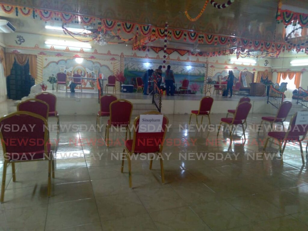 Empty chairs, one with a sign that says Sinopharm, at Scott's Mendez Shiva Mandir, a covid19 vaccination site in Penal on Saturday. - PHOTO BY LAUREL V WILLIAMS 