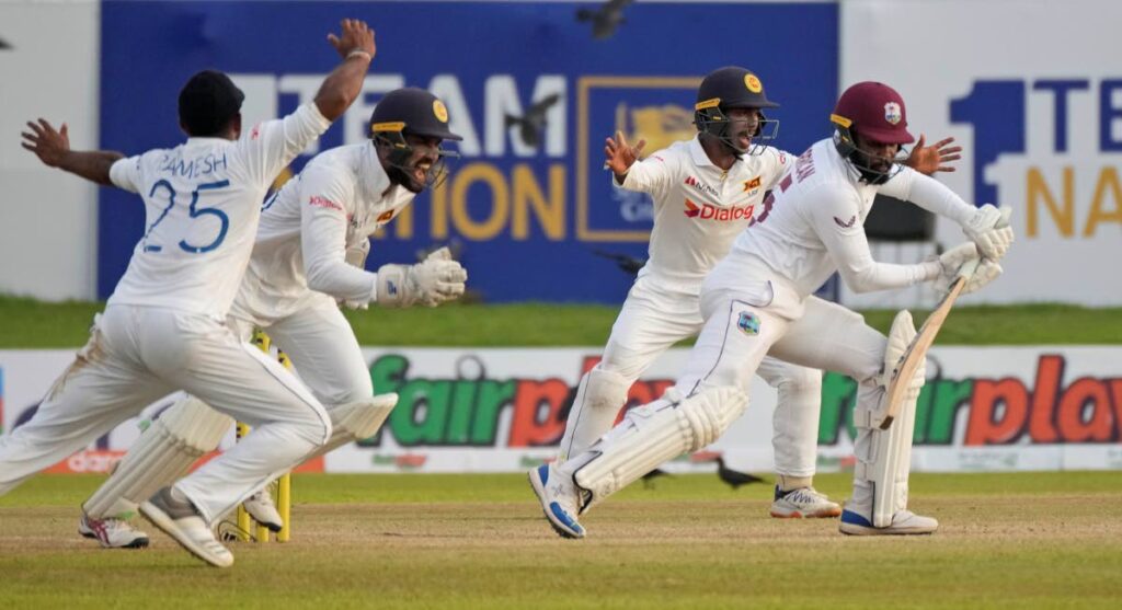 Sri Lanka's wicketkeeper Dinesh Chandimal (second left), celebrates taking a catch to dismiss West Indies' batsmen Jomel Warrican during the day two of their first Test between Sri Lanka and West Indies' in Galle, Sri Lanka, on Monday. (AP PHOTO) 