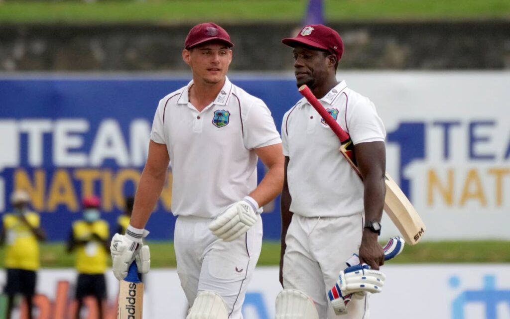 West Indies batsmen Joshua Da Silva (left) and Nkrumah Bonner walk back to pavilion as the play stopped due to bad light during the fourth day's play of the first Test between Sri Lanka and West Indies in Galle, Sri Lanka, on Wednesday. (AP PHOTO) - 