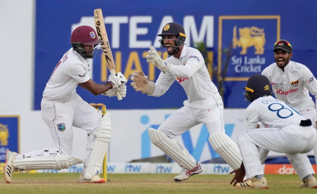 Sri Lankan wicketkeeper Dinesh Chandimal celebrates the dismissal of West Indies captain Kraigg Brathwaite during the fourth day of the first Test in Galle, Sri Lanka, on Wednesday. (AP Photo) 