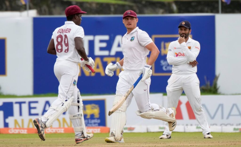 West Indies batsmen Nkrumah Bonner, left, and Joshua Da Silva run between wickets as Sri Lankan captain Dimuth Karunaratne watches during the fifth day of the first Testmatch in Galle, Sri Lanka, on Thursday. AP Photo - 
