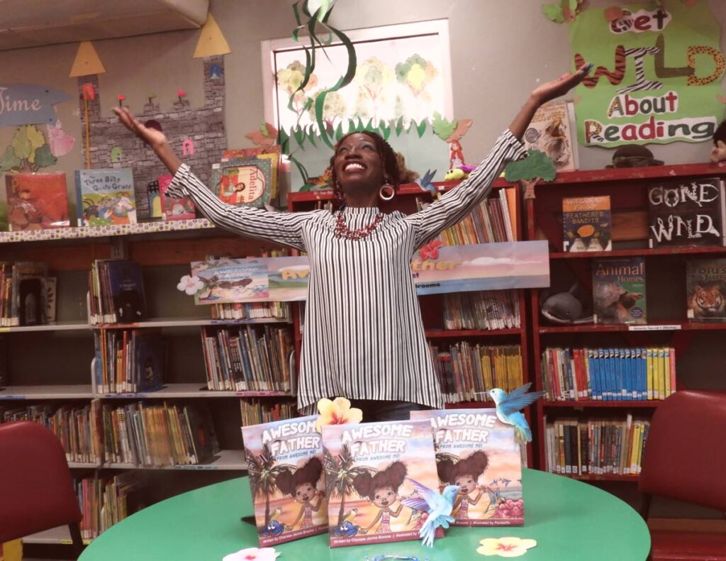 Charisse Broome celebrates at the launch of her children's book, Awesome Father, at the Tunapuna Library. - 
