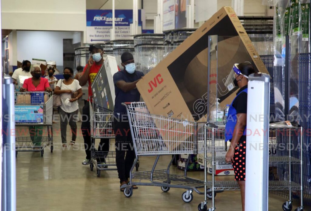 MOVIES TONIGHT: Two men leave Pricesmart, MovieTowne, Port of Spain with their flat screen, smart TVs as they took advantage of Black Friday sales. PHOTO BY SUREASH CHOLAI   - 