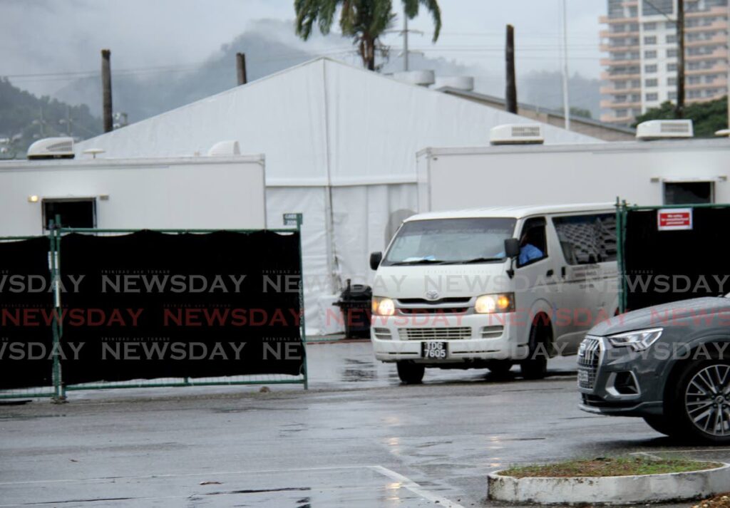 A hearse exits the field hospital at the Jean Pierre Complex, Port of Spain on Saturday, one of the sites where where critical covid19 patients are treated.  - AYANNA KINSALE