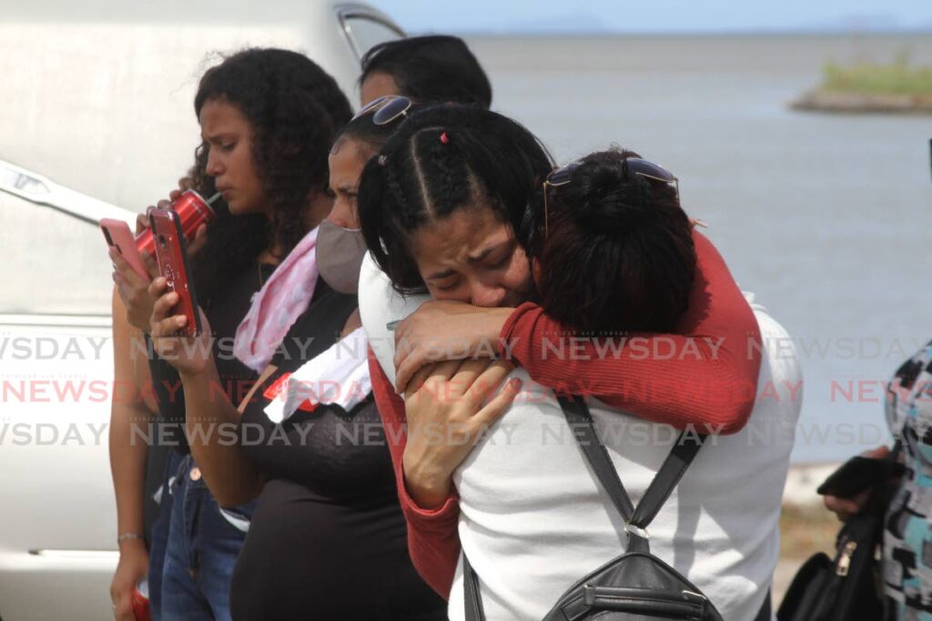 Mourners at the Waterloo Cremation Site on Monday following the funeral service of Venezuelan Charlys Agosto Polo Mata, 22, who was stabbed to death in Freeport on Sunday. - Photo by Marvin Hamilton