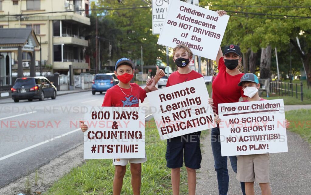 Members of Open Schools TT protest over the continued closure of schools at the Queen's Park Savannah, Port of Spain, on Monday. - ROGER JACOB