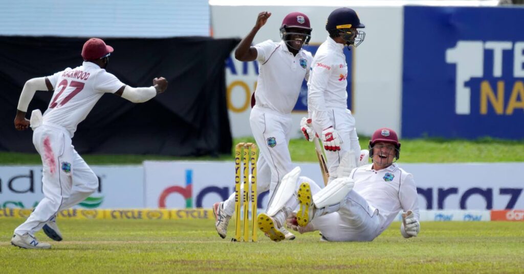 West Indies wicketkeeper Joshua Da Silva (bottom) celebrates taking a catch to dismiss Sri Lankan batsmen Dhananjaya de Silva during the day two their second Test in Galle, Sri Lanka, on Tuesday. (AP PHOTO) - 