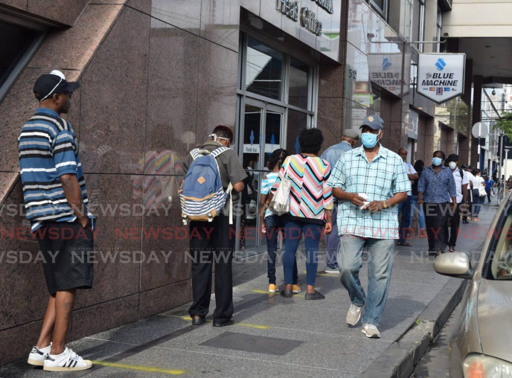 Customers wait to enter Republic Bank's head office on Park Street, Port of Spain. File photo - 