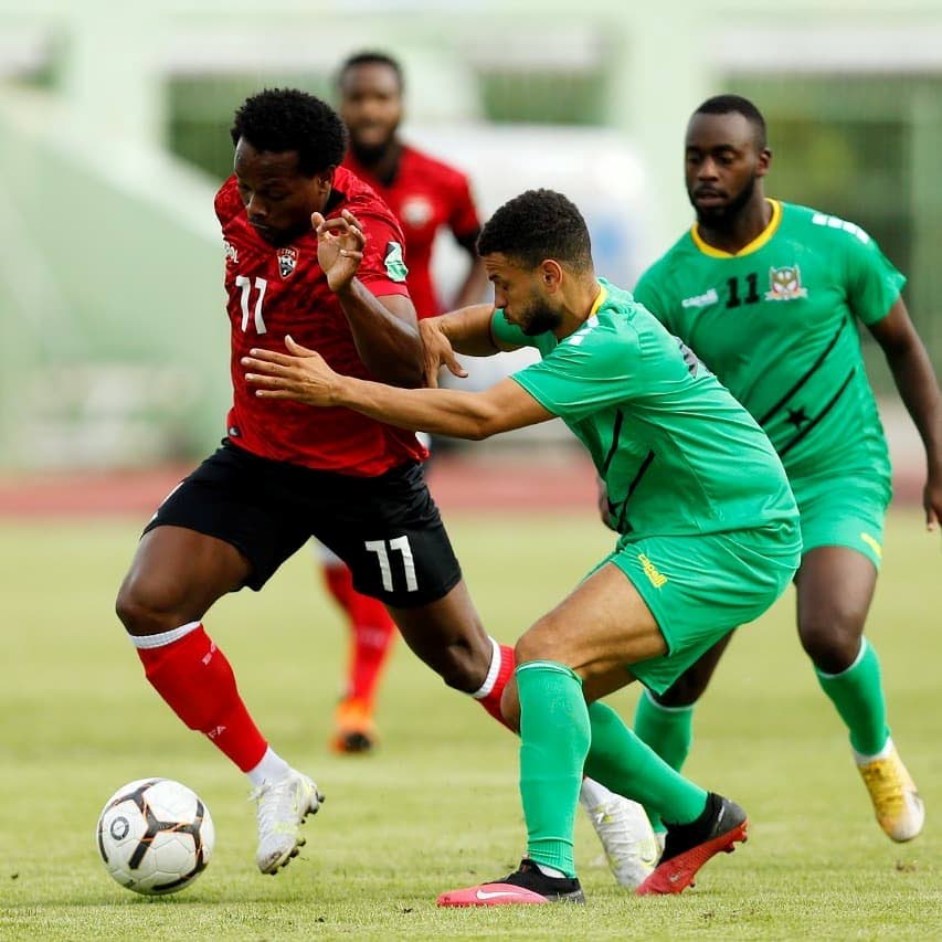 In this June 8 file photo, TT’s Levi Garcia (L) evades a St Kitts/Nevis player in the 2022 Fifa World Cup Concacaf Zone qualifier, at the Felix Sanchez Stadium, Dominican Republic, on Tuesday. Garcia has been named as one of the nominees for the TTFA’s senior men’s player of the year award. - via TTFA Media