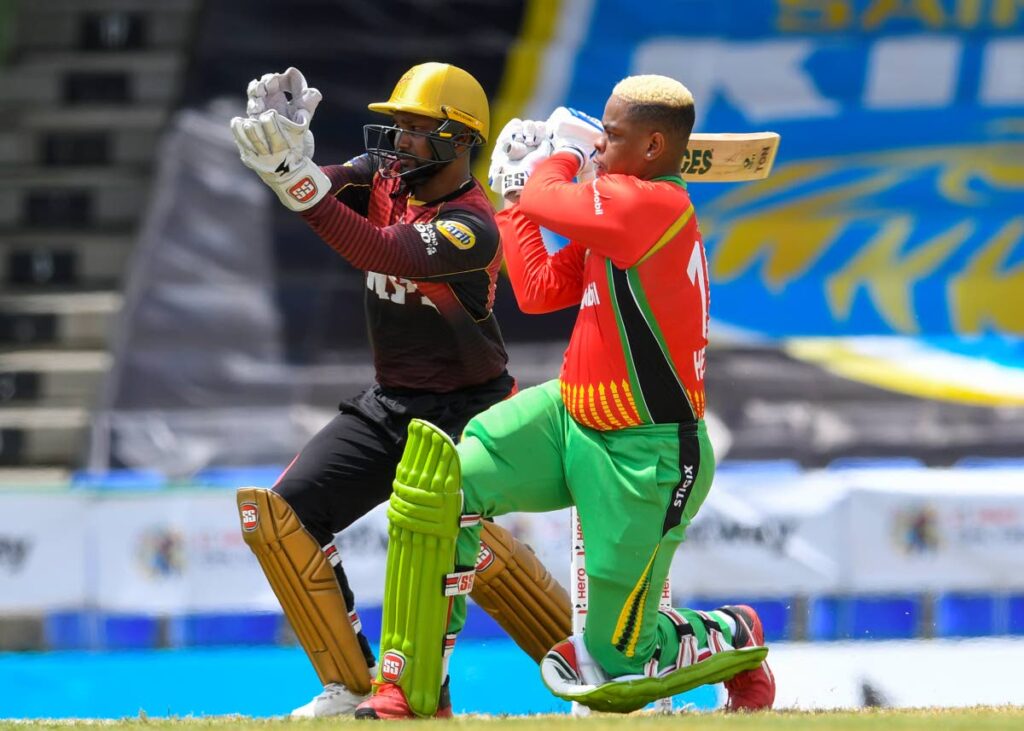 In this August 26, 2021 file photo, Shimron Hetmyer (right) of Guyana Amazon Warriors hits a four as Denesh Ramdin of Trinbago Knight Riders looks on during the teams' Hero Caribbean Premier League at Warner Park Ground, Basseterre, St Kitts. (PHOTO COURTESY CPL T20) - 