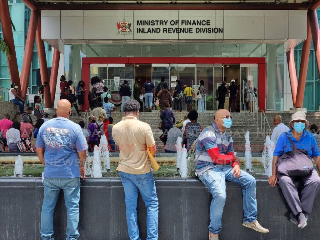 People wait to file tax returns outside the Ministry of Finance, Inland Revenue Division, Port of Spain during the final days of a tax amnesty in October. The TT Revenue Authority is expected to improve tax collection. - File photo/Jeff Mayers 