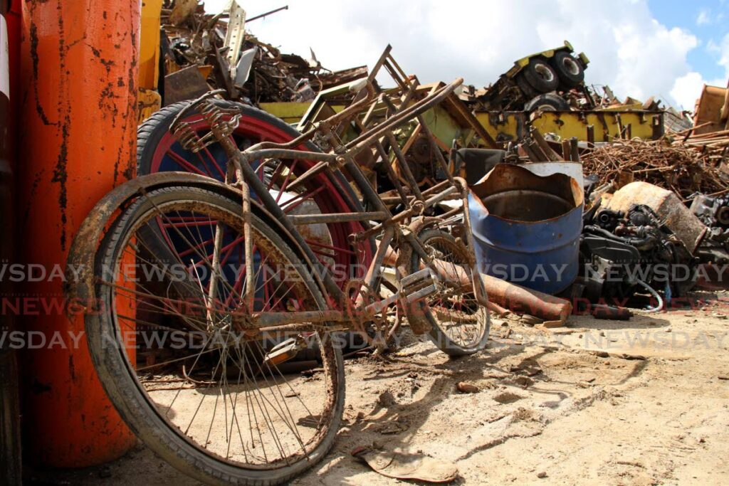 Materials from old bikes to cars are sources of scrap iron at West Indian Salvage and Recycling Co Ltd, Bypass Road, Kelly Village, Caroni. Dealers want government to develop a new policy for the industry. - PHOTO BY AYANNA KINSALE