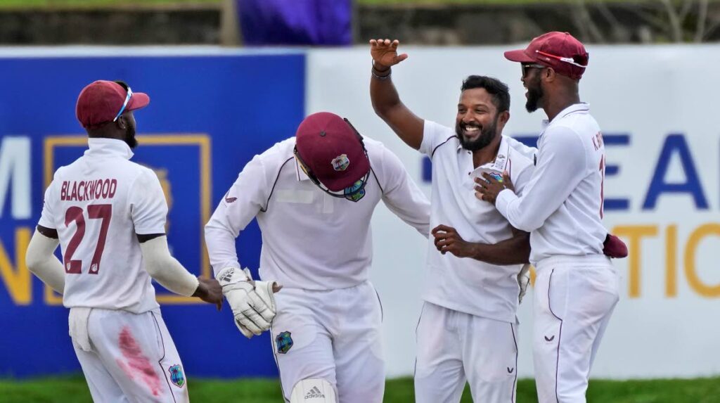 West Indies bowler Veerasammy Permaul, second right, is congratulated by his teammates for taking five Sri Lankan wickets during the day two their second Test match in Galle, Sri Lanka, on Tuesday. (AP Photo) - 