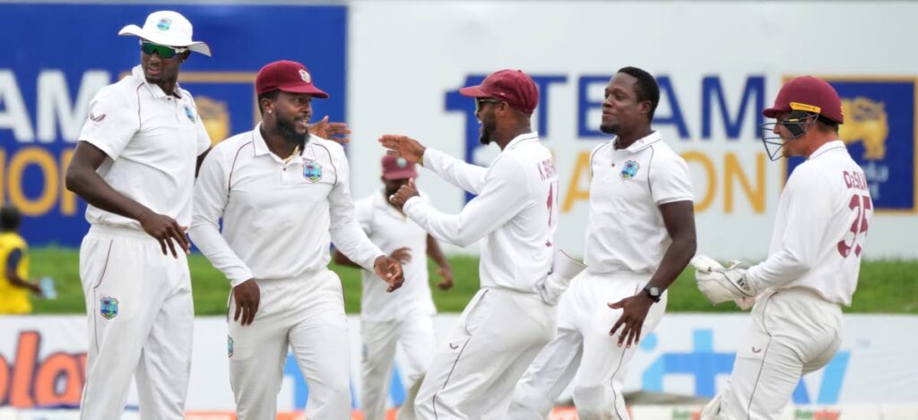 West Indies team members congratulate Kyle Mayers, second left, for taking a run out to dismiss Sri Lankan captain Dimuth Karunaratne during day three of the second Test match in Galle, Sri Lanka, on Wednesday. AP Photo - 