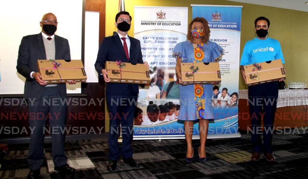 From left the Education Ministry PS Kurt Meyer, CAF representative Gianpiero Leoncini, Education Minister Dr Nyan Gadsby Dolly and UNICEF (Barbados)   representative Fiaz Shah. The Development Bank of Latin America, CAF and UNICEF, presented laptops to the Ministry of Education at the handover ceremony at the ministry's head office on St Vincent Street, Port of Spain. Photo by Sureash Cholai