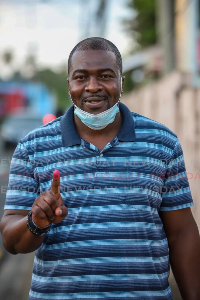 PNM candidate for Bon Accord/Crown Point Clarence Jacob shows his voting finger outside the Bon Accord Government Primary School on Monday. Photo by Jeff K Mayers