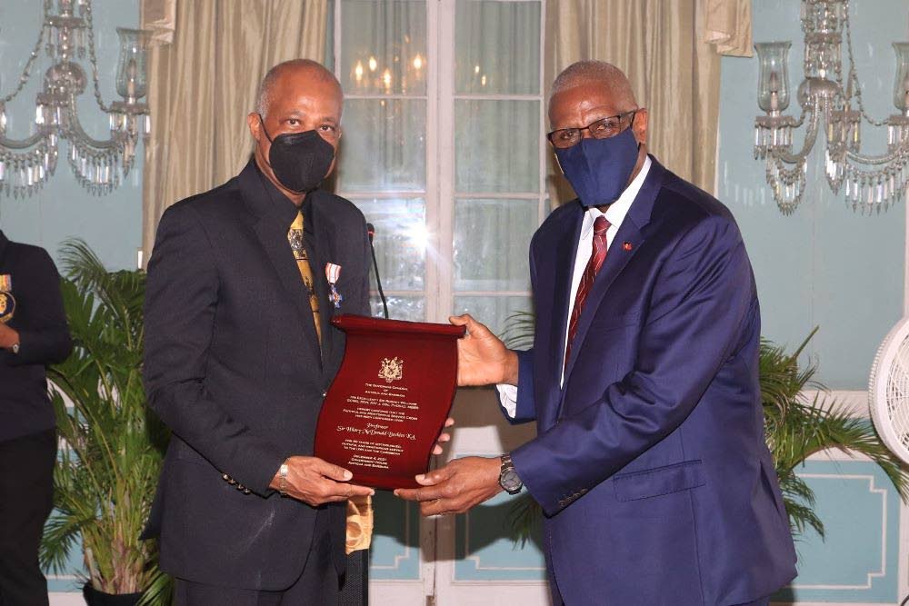  Governor-General of Antigua and Barbuda Rodney Williams presents the Governor General's Faithful and Meritorious Award's highest honour, the Cross and Plaque to
Professor Hilary Beckles. - courtesy Photogenesis Imaging