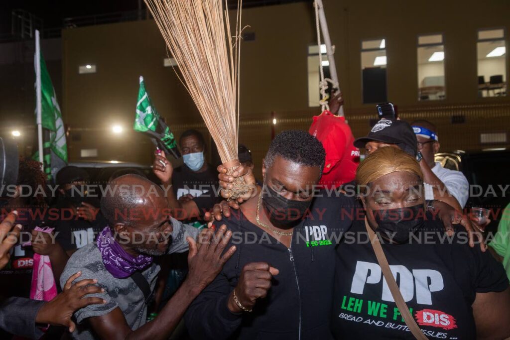 PDP political leader Watson Duke is swarmed by supporters in Roxborough after his party won the THA election on Monday. - David Reid