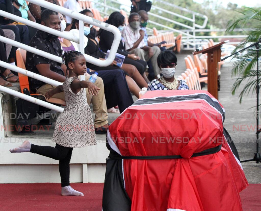 Aniyah Sariah Jones, daughter of murdered prison officer Nigel Michael Jones, dances at his funeral at the Irwin Park Sporting Complex, Siparia on Tuesday. Jones was murdered in front of his daughter on November 29.  Photo by Angelo Marcelle