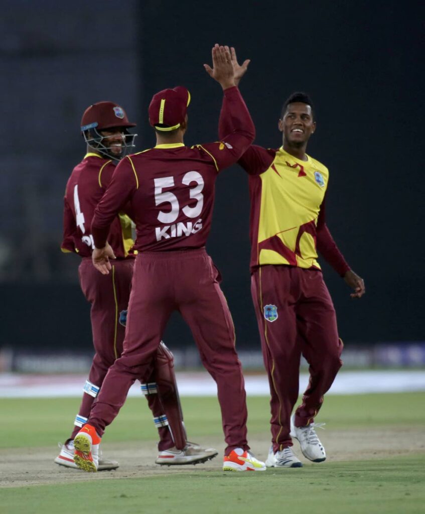 West Indies Akeal Hosein, right, celebrates with teammates after taking the wicket of Pakistan's Babar Azam during the first Twenty20 international at the National Stadium, in Karachi, Pakistan, on Monday.  - 