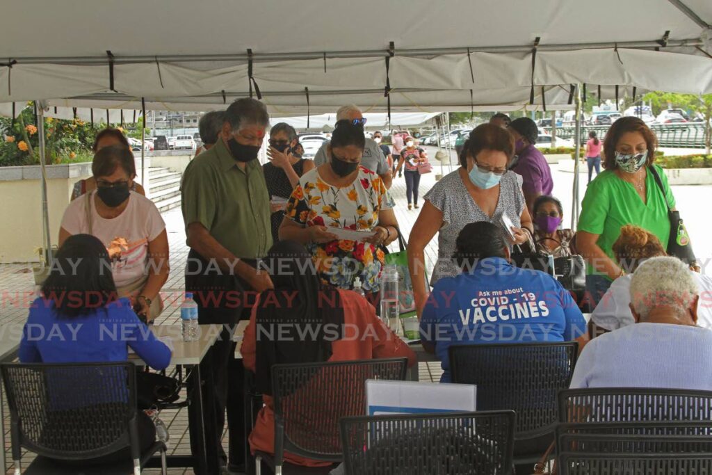 Southerners show up at the Southern Academy for the Performing Arts mass vaccination site in San Fernando on Monday, as the vaccination booster programme began. - Marvin Hamilton