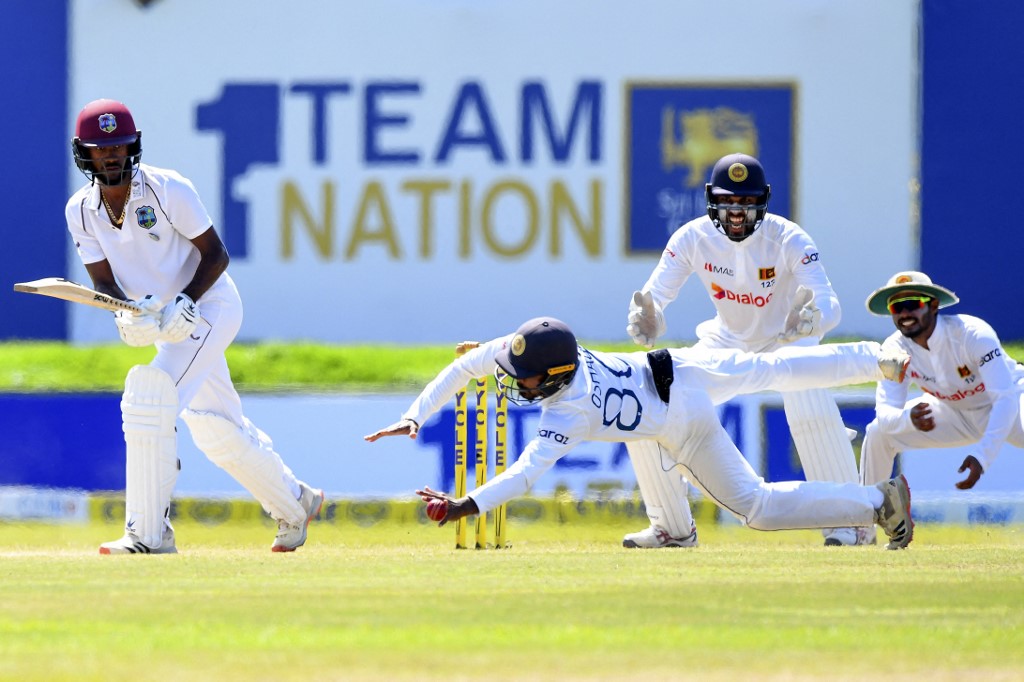 Sri Lanka's Oshada Fernando (C) drops the catch of West Indies' captain Kraigg Brathwaite (L) on the fifth and final day of the second Test cricket match between Sri Lanka and West Indies at the Galle International Cricket Stadium in Galle on December 3, 2021. (Photo by ISHARA S. KODIKARA / AFP)