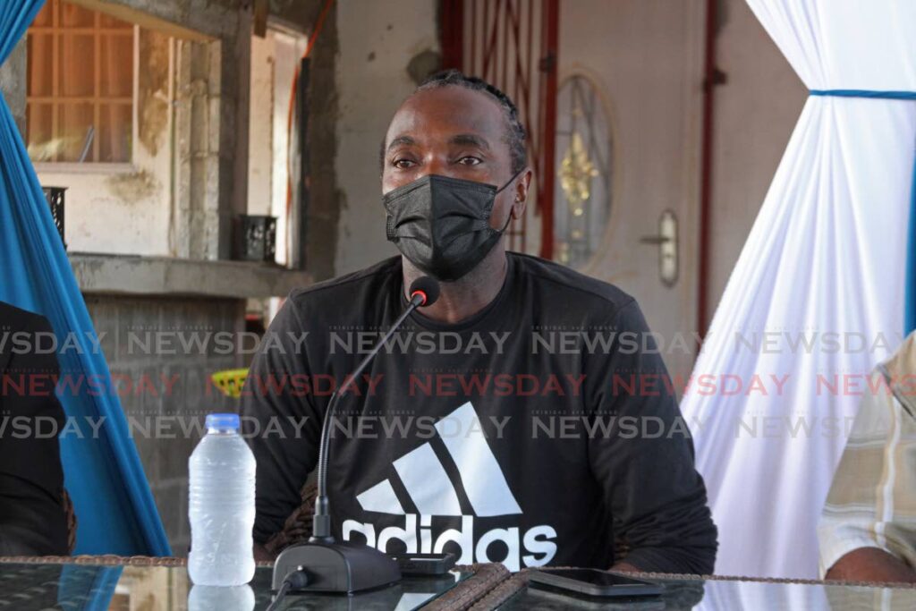 Chairman of the NGO La Brea Action Group Shaun Edmund speaks at a meeting hosted by the Scrap Iron Dealers Association president Allan Ferguson on High Road in La Brea on Wednesday morning. - Photo by Marvin Hamilton