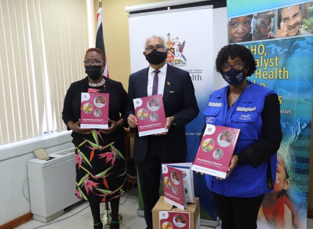 Dr Erica Wheeler, Pan American Health Organization (PAHO) country representative, right, presents book on breastfeeding to Terrence Deyalsingh Minister of Health, centre, and Debra Thomas, manager of the National Breastfeeding Coordinating Unit. - 